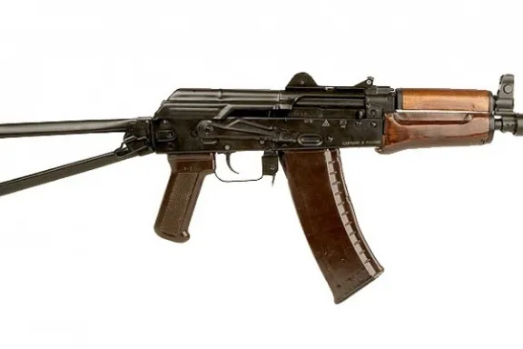 AK-47 rifle with wooden grips, angled stock, and curved magazine.
